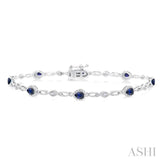 1/20 Ctw Pear Cut 4X3 MM Ruby and Round Cut Diamond Precious Fashion Bracelet in 10K White Gold